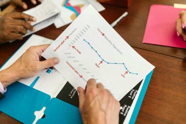 a person holding a report paper